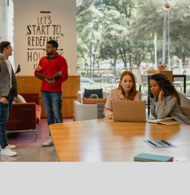 Team collaborating at a modern office space with natural light and open seating