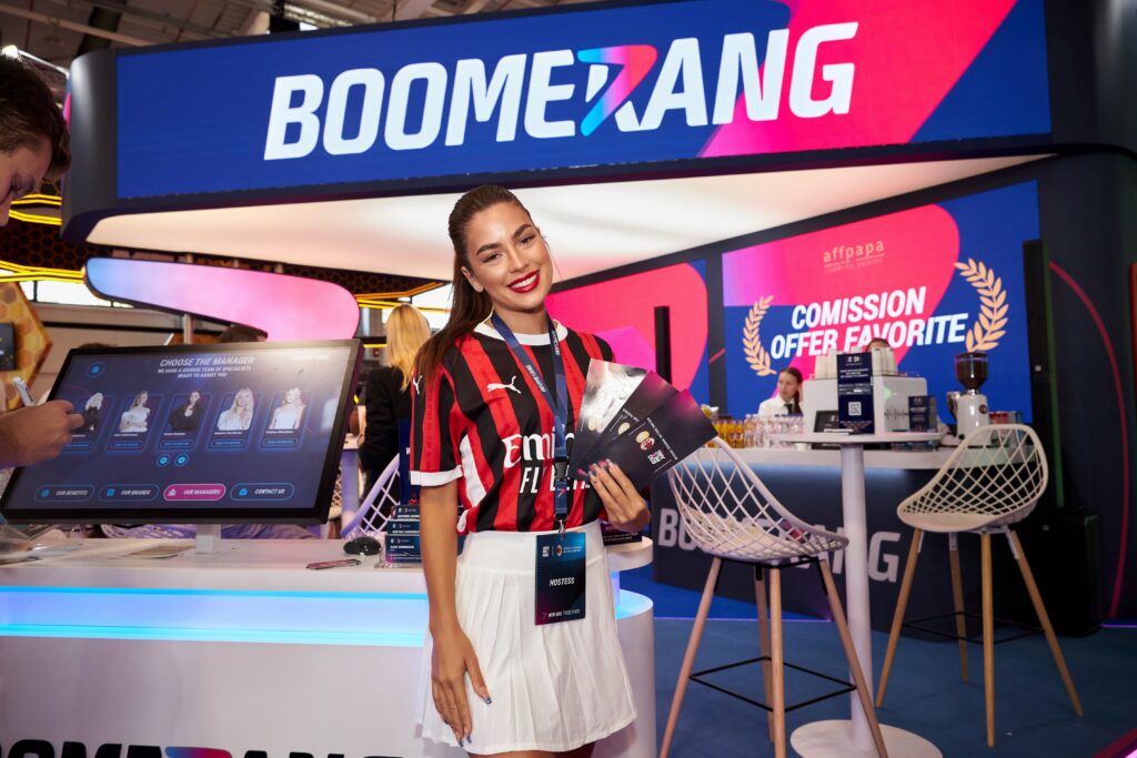 Hostess at Boomerang exhibition booth showcasing brand materials and engaging with visitors