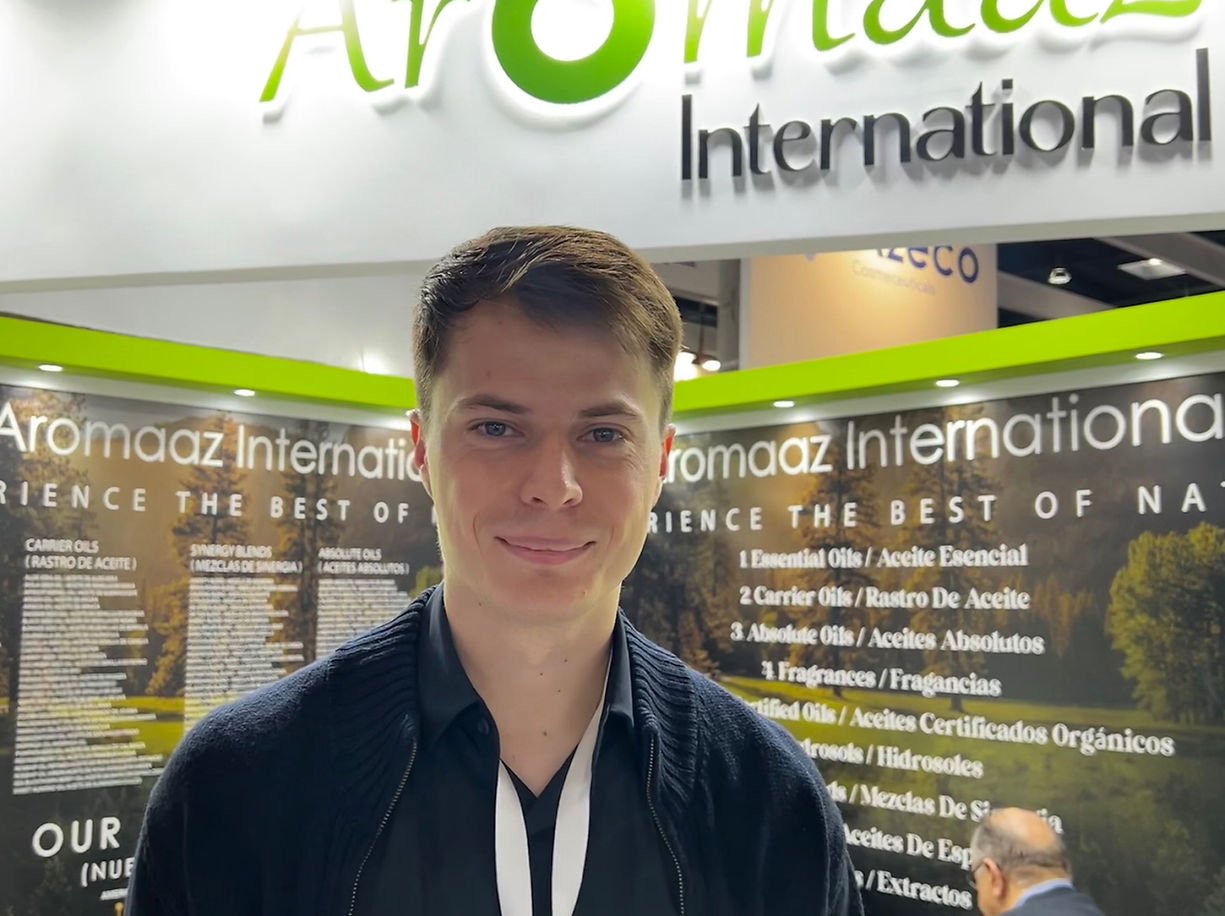 Professional representing Aromaaz International at an exhibition booth